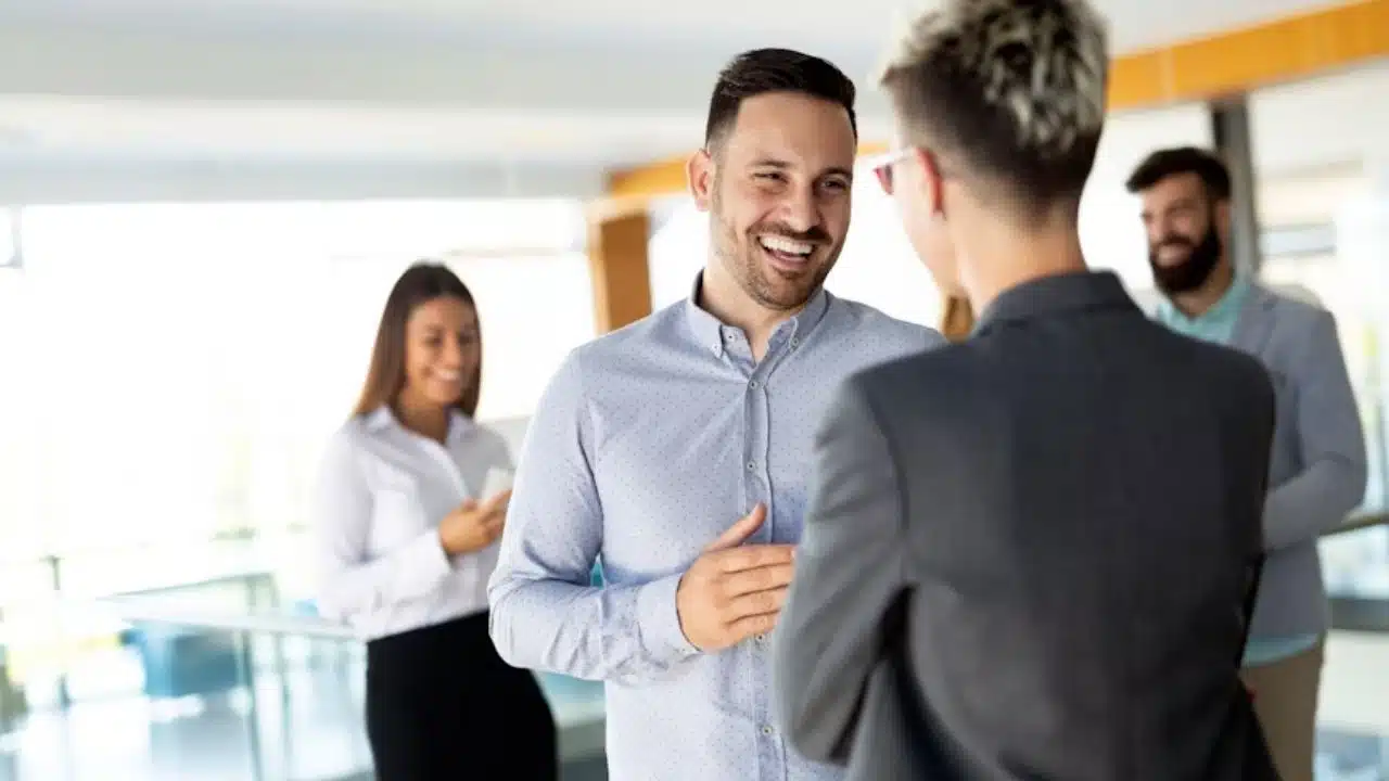 Man speaking confidently during a meeting or social setting