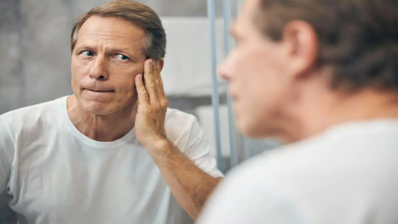 A man looking at the mirror