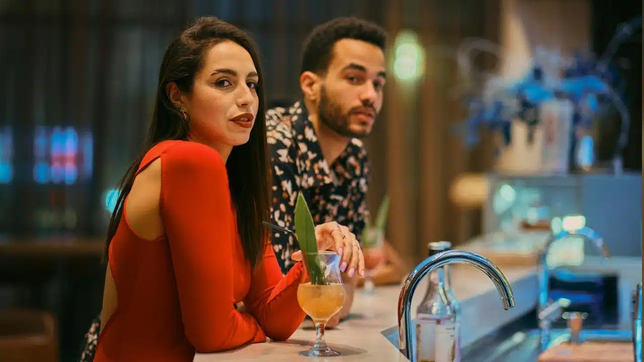 A man and a woman at a bar.